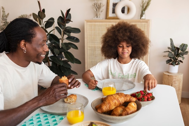 Little girl having breakfast with her father