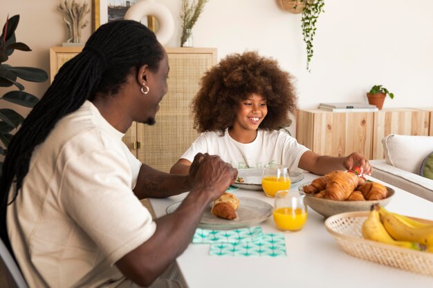 Little girl having breakfast with her father