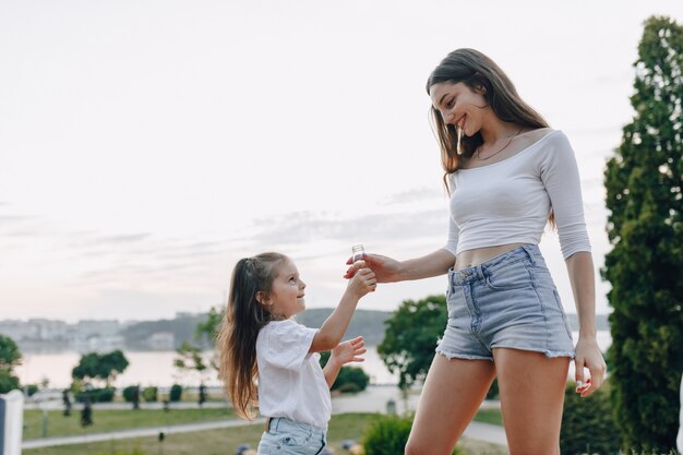 Little girl having fun at picnic, pizza, drinks, summer and lawn