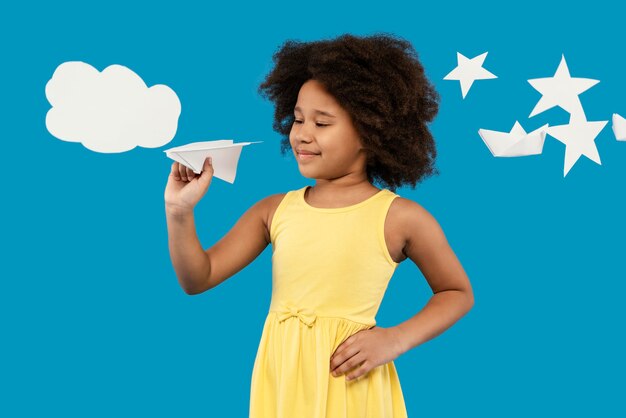 Little girl having fun in a summer setting studio