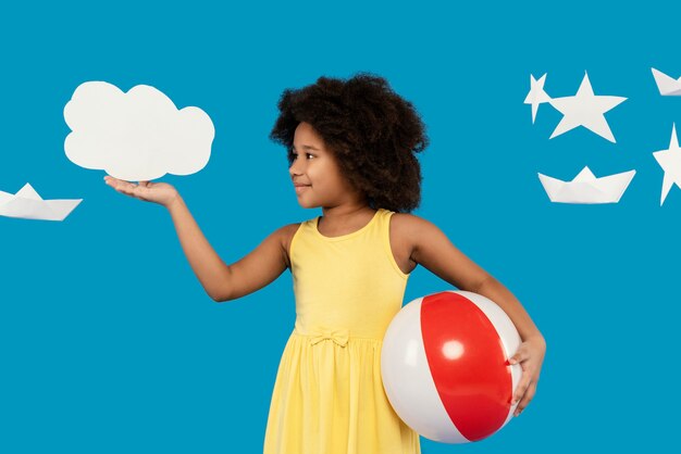 Little girl having fun in a summer setting studio