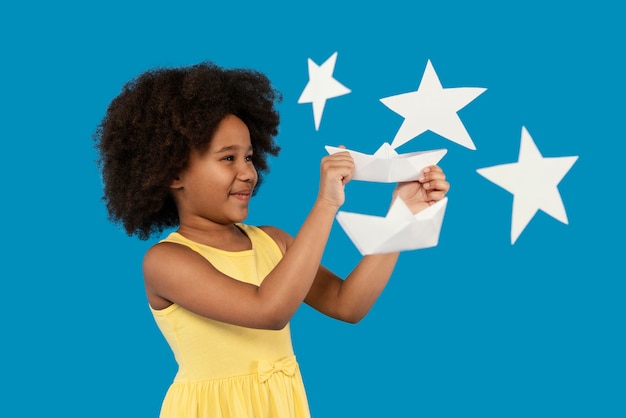 Free photo little girl having fun in a summer setting studio