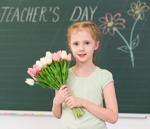 Little girl holding a bouquet of flowers