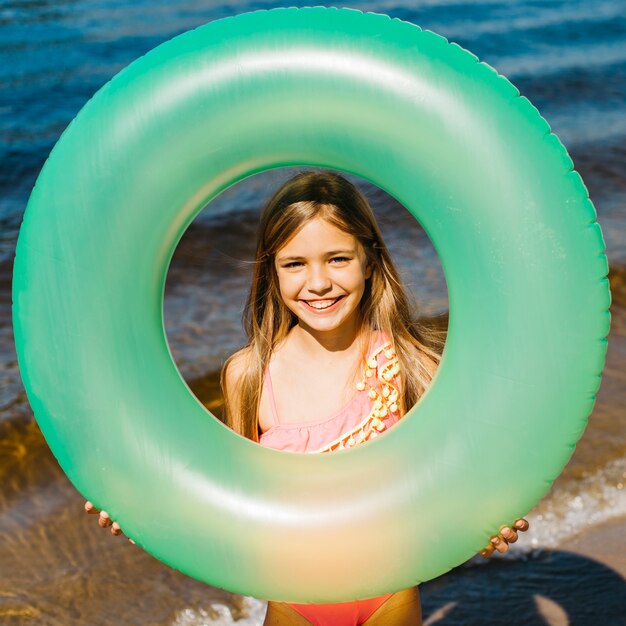 Little girl holding inflatable swimming ring