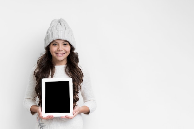 Little girl holding tablet device mock-up