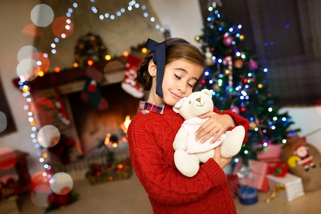 Little girl hugging a teddy bear