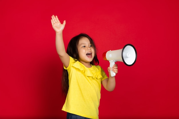 Free photo little girl isolated on red, happy