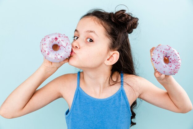 Little girl kissing delicious doughnut
