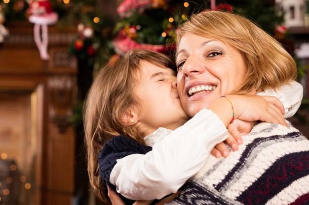 Little girl kissing her mother in the face