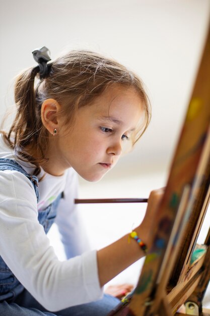 Little girl learning how to paint