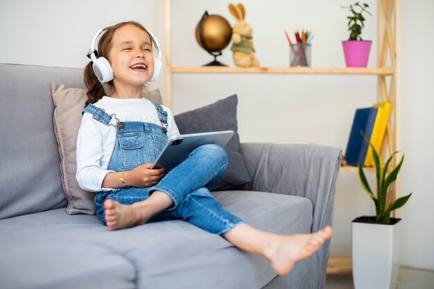 Little girl listening to music through headphones