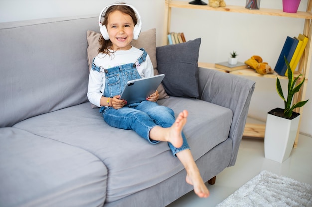 Little girl listening to music through headphones