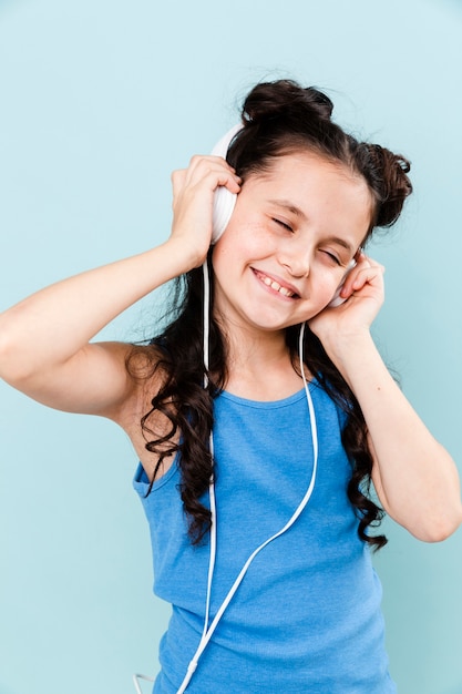 Free photo little girl living the music at headphones