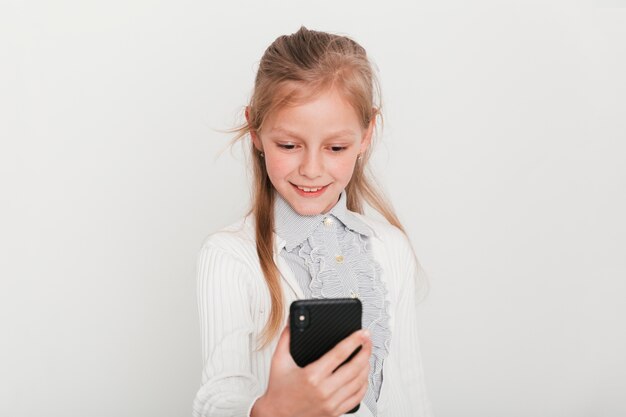 Little girl looking at her smartphone