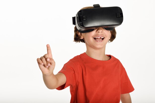 Little girl looking in VR glasses and gesturing with his hands.