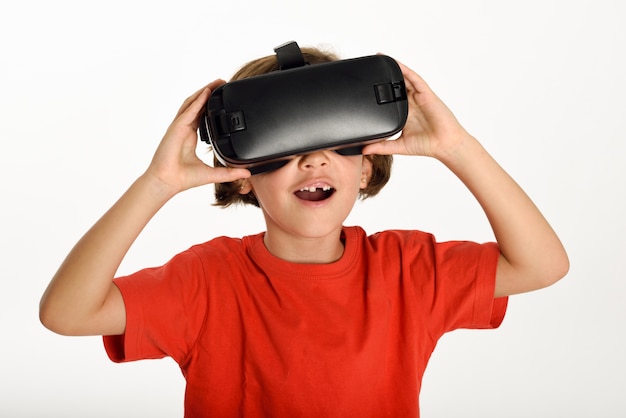 Little girl looking in VR glasses and gesturing with his hands.