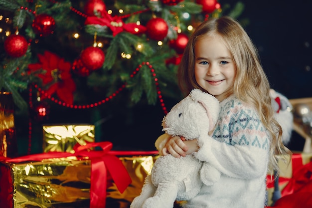 Free photo little girl near christmas trre