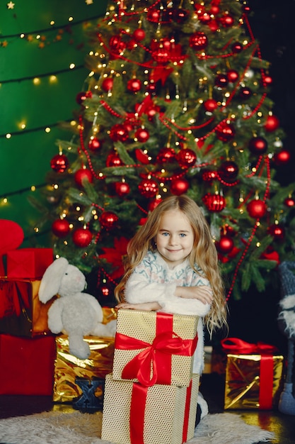 Free photo little girl near christmas trre