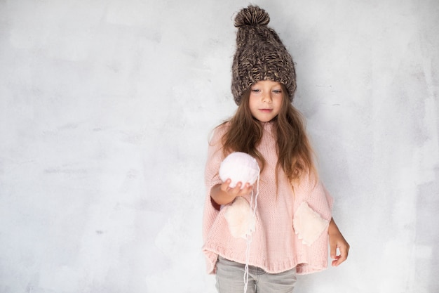 Little girl offering a snowball