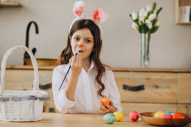 Little girl painting eggs for easter