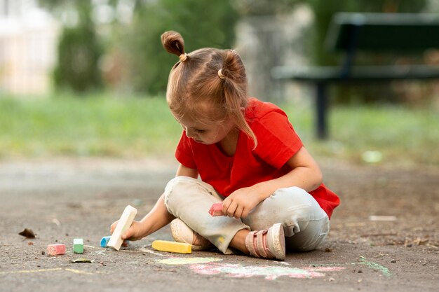 Little girl in park drawing