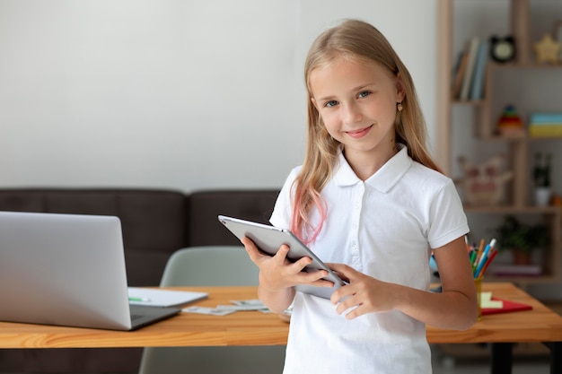 Little girl participating in online classes at home