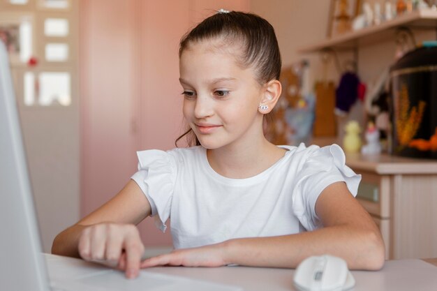 Little girl paying attention on online lessons