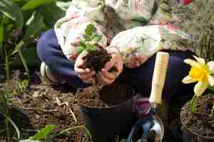 Free photo little girl planting flowers in the garden