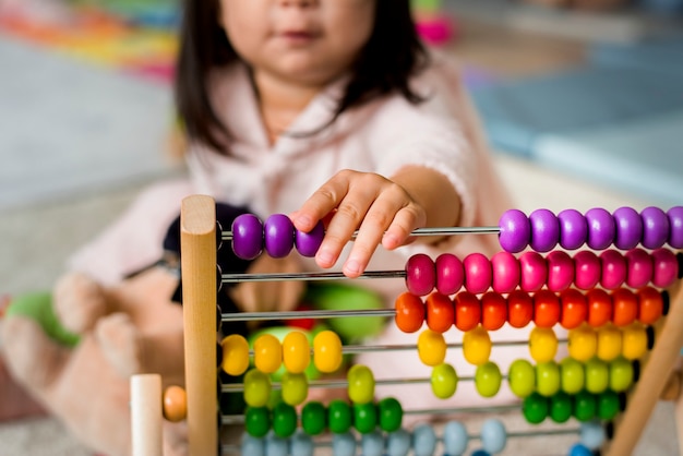 Little girl playing abacus for counting practice