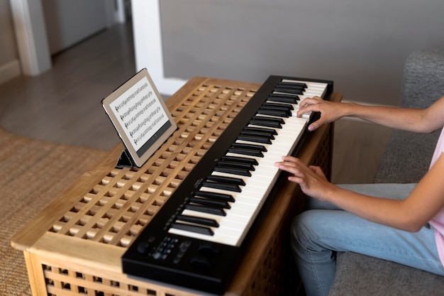 Little girl playing keyboard at home