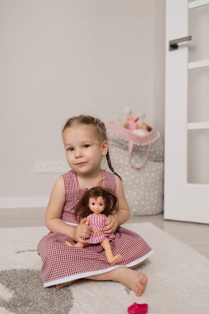 Little girl playing with a doll