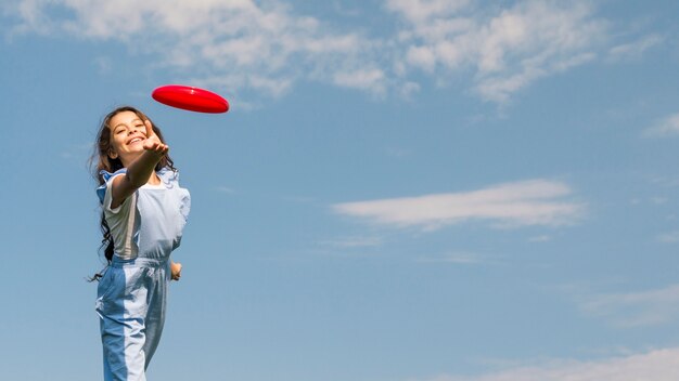 Little girl playing with frisbee 