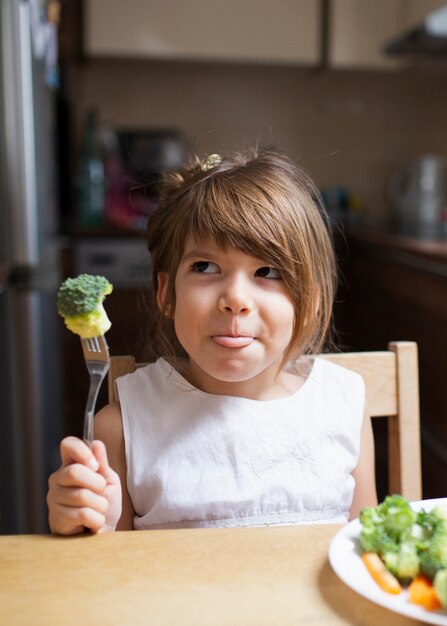 Little girl playing with healthy food