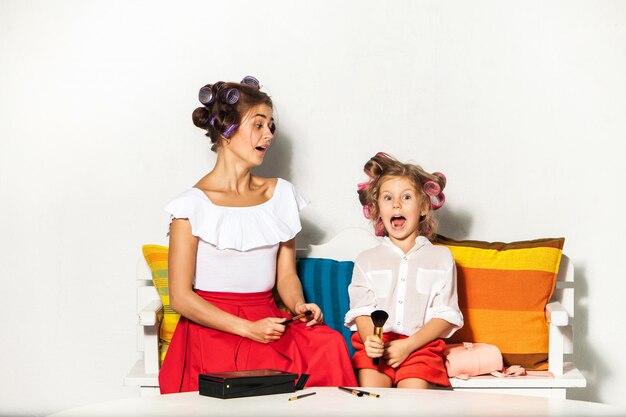 Little girl playing with her mom's makeup