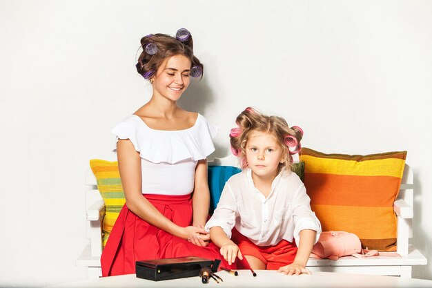 Little girl playing with her mom's makeup