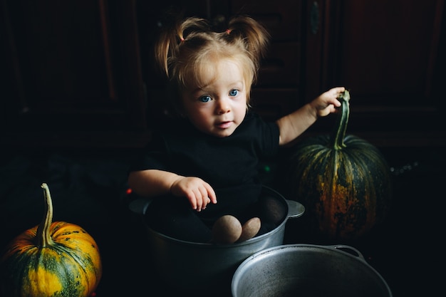 Free photo little girl playing with pumpkin