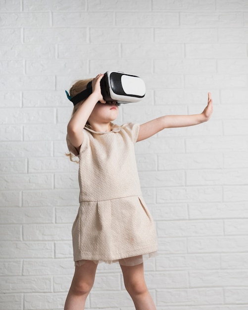 Little girl playing with virtual reality headset