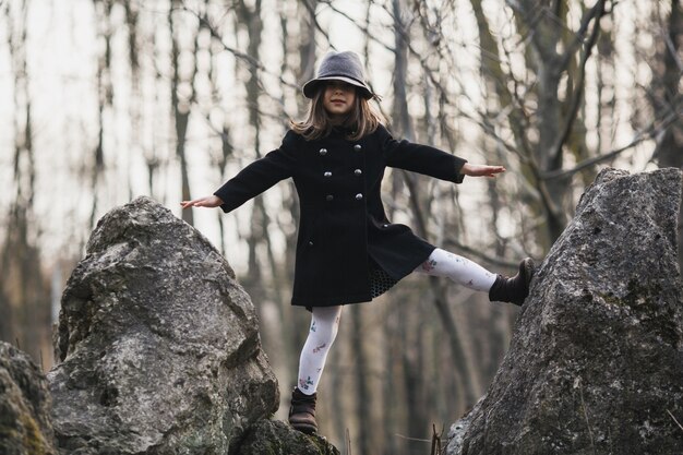 Little girl posing on rocks