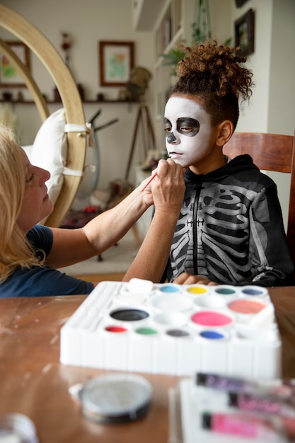 Little girl preparing for halloween with a skeleton costume