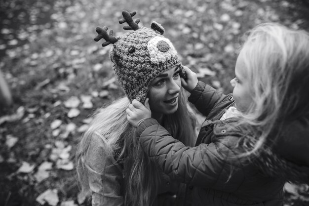 Little girl putting a cap on her mother