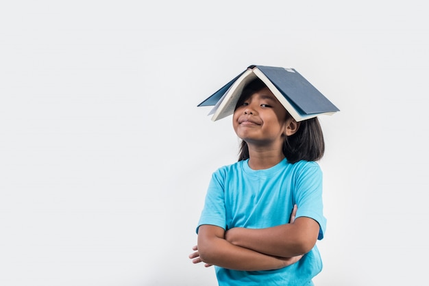 little girl reading book in studio shot