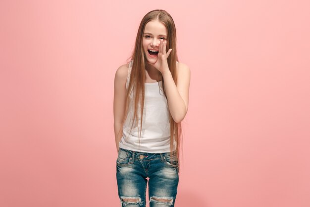 Little girl shouting isolated on pink wall