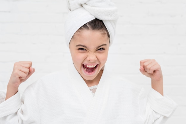 Free photo little girl shouting in a white robe