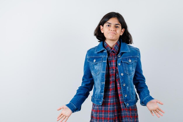 Free photo little girl showing helpless gesture in shirt, jacket and looking perplexed , front view.