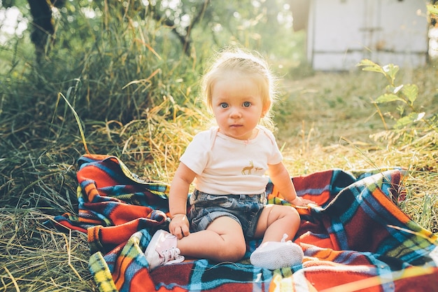 little girl sitting alone on the lawn