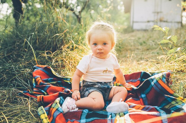 little girl sitting alone on the lawn