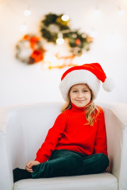 Little girl sitting in chair on Christmas