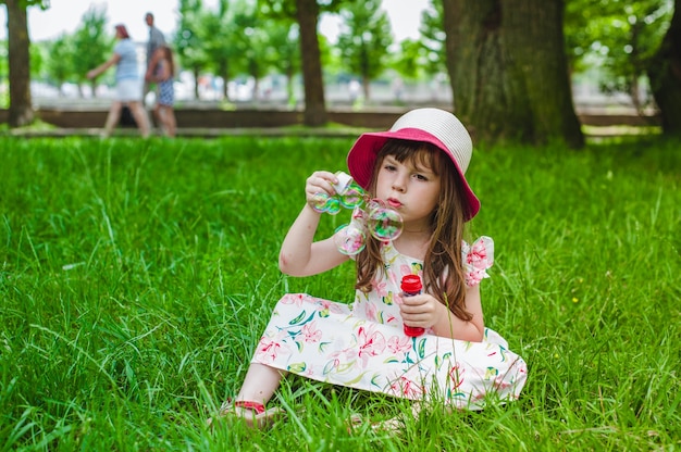 Little girl sitting on the floor with a pompous