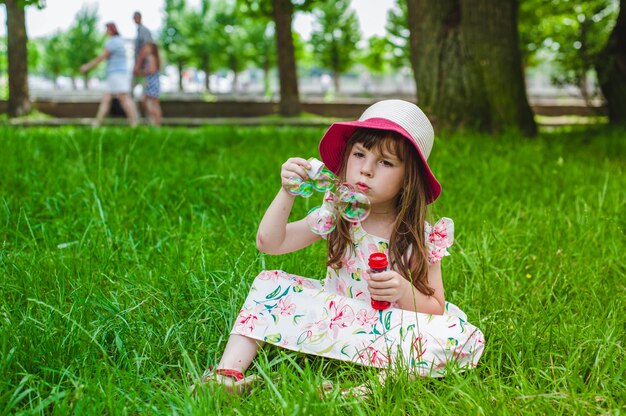 Little girl sitting on the floor with a pompous