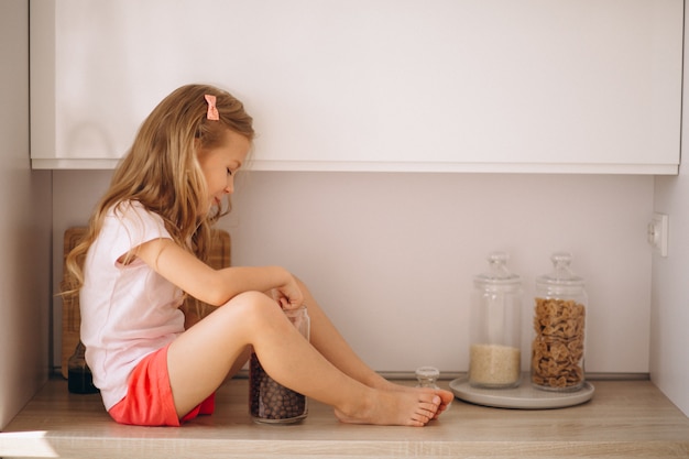 Little girl sitting at the kitchen